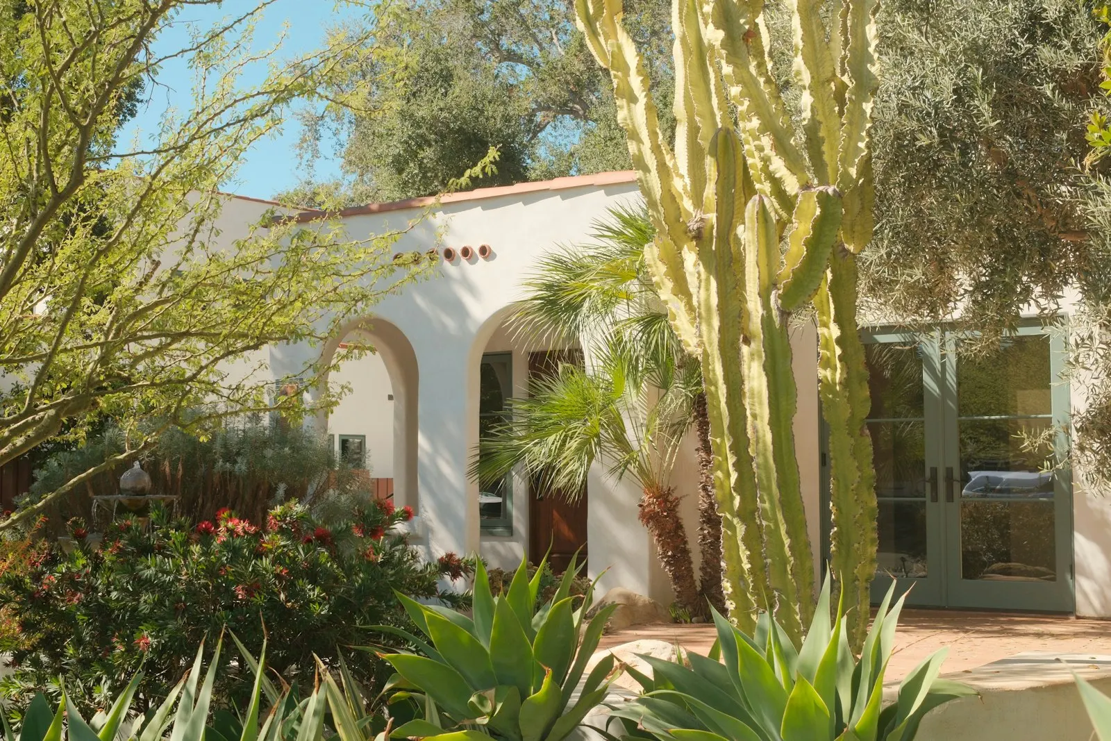Spanish-style stucco home with desert front yard, paver walkway and cacti, far-west Maricopa